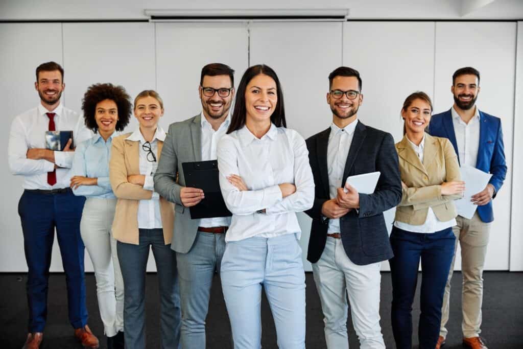 An American Computer Services, Inc. IT Consulting Team smiling in an office setting. 